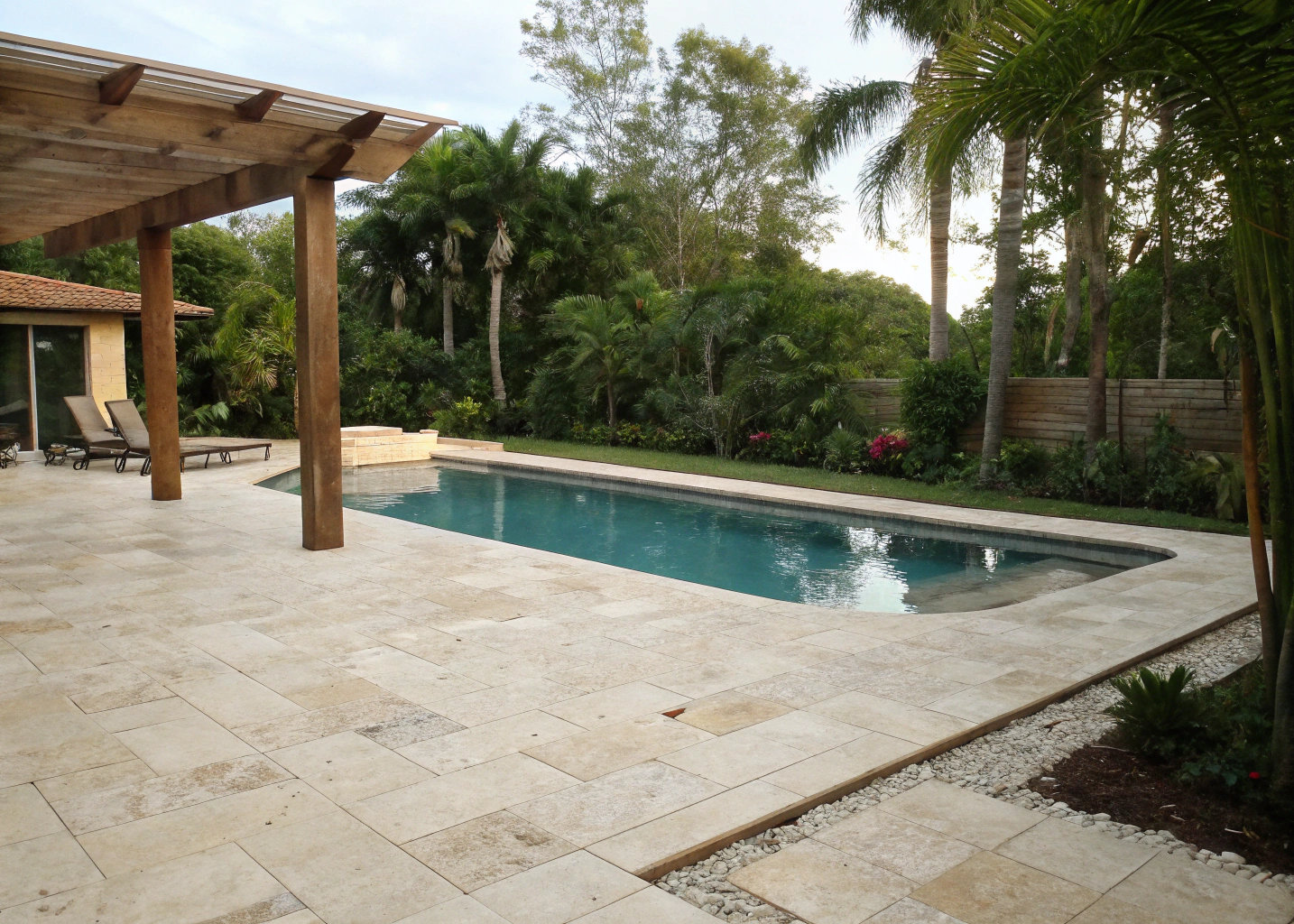 Travertine pool pavers around a resort-style residential pool surround